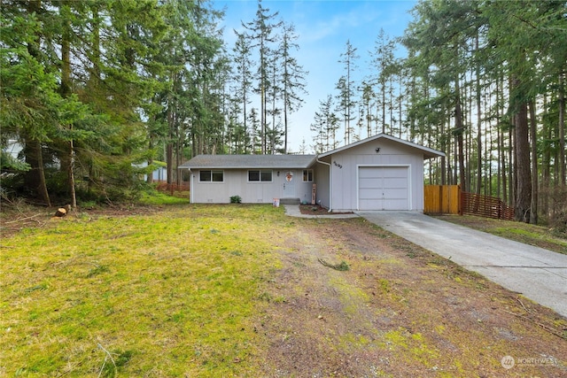 single story home featuring a garage and a front lawn