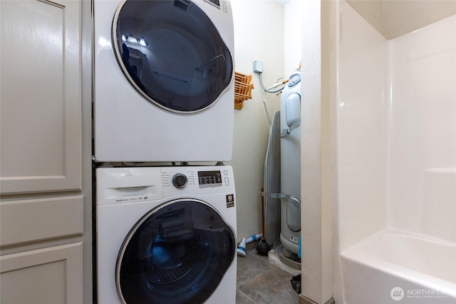 laundry room with stacked washer / dryer