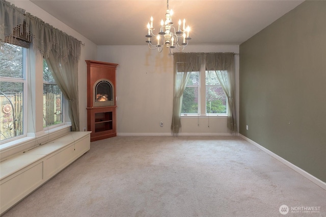 unfurnished dining area featuring a chandelier and light colored carpet