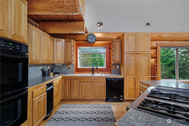 kitchen with log walls, a healthy amount of sunlight, black appliances, and sink