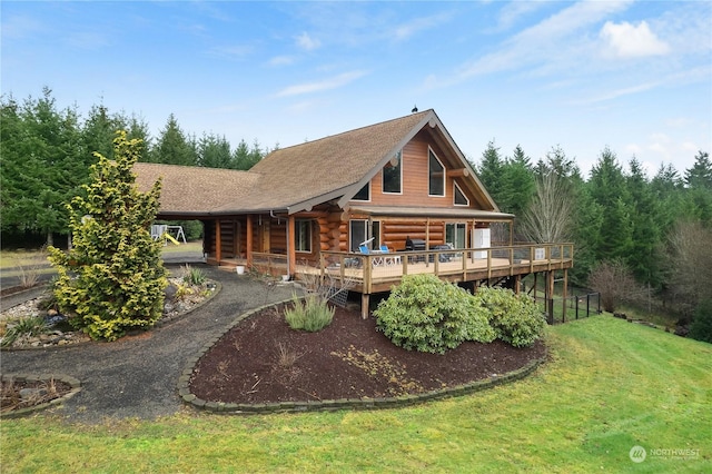 rear view of property with a lawn and a deck