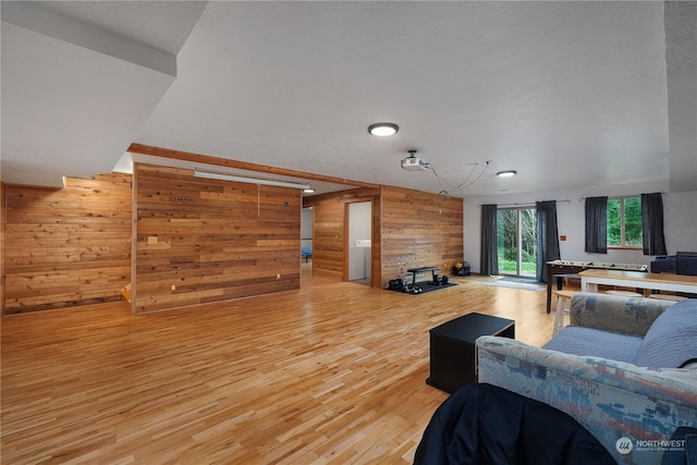 living room with wood walls and hardwood / wood-style floors