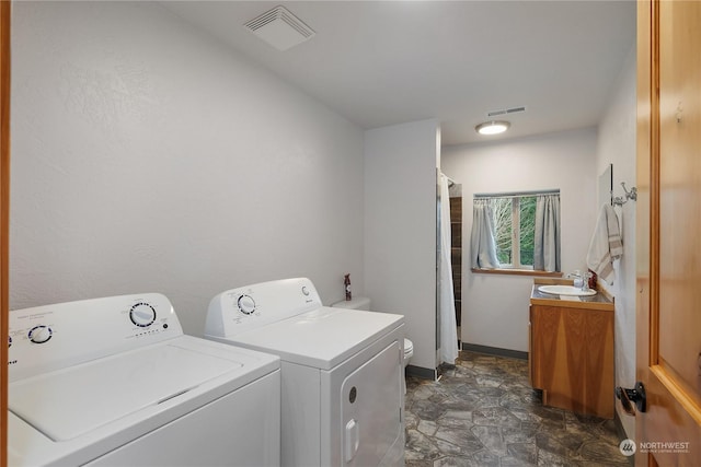 laundry area featuring sink and washing machine and clothes dryer