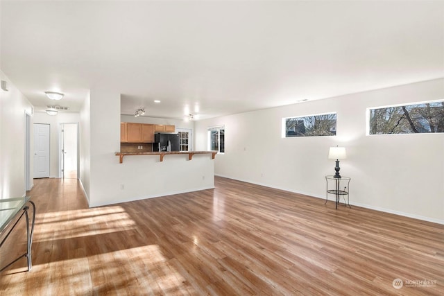 unfurnished living room featuring light wood-type flooring