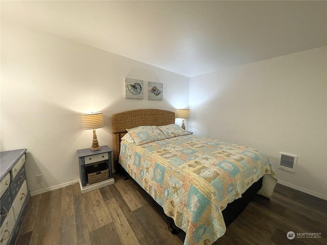 bedroom with dark wood-type flooring