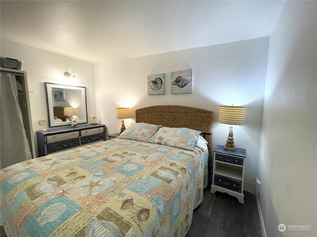 bedroom with dark wood-type flooring