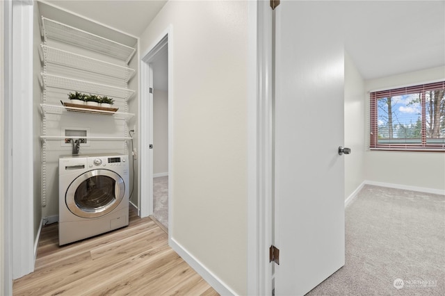 washroom with light hardwood / wood-style floors and washer / dryer