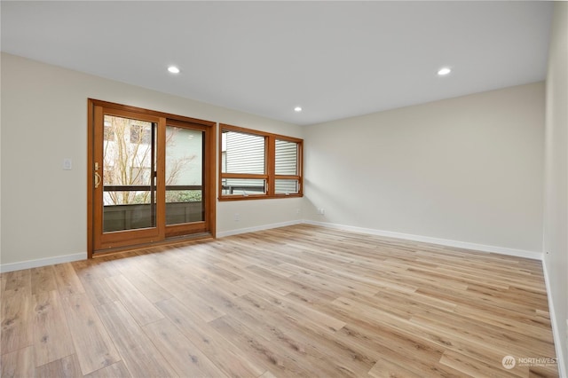 spare room with light hardwood / wood-style flooring