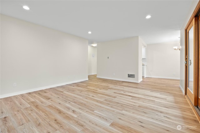 spare room featuring light hardwood / wood-style floors