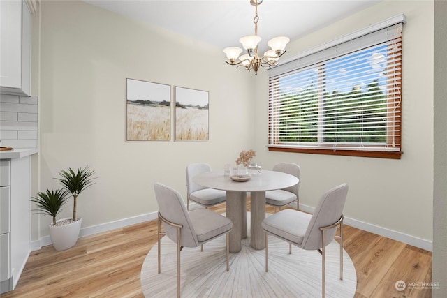 dining room featuring a notable chandelier and light hardwood / wood-style flooring