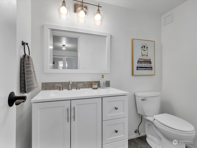 bathroom featuring vanity and toilet