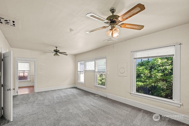 unfurnished room featuring carpet flooring and plenty of natural light