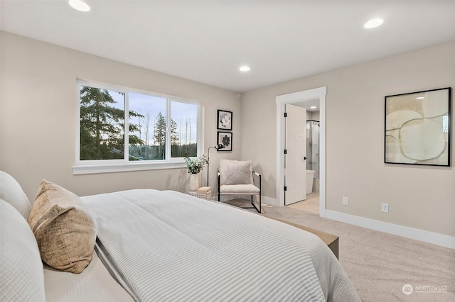 carpeted bedroom featuring ensuite bath