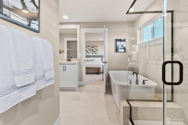 bathroom featuring vanity, tile patterned floors, and shower with separate bathtub