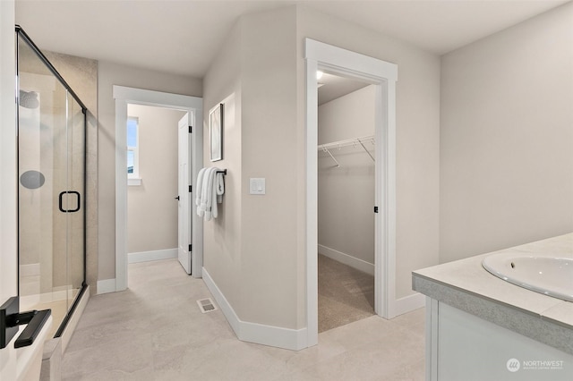 bathroom with vanity and an enclosed shower