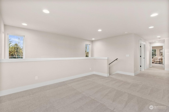 carpeted spare room featuring a wealth of natural light