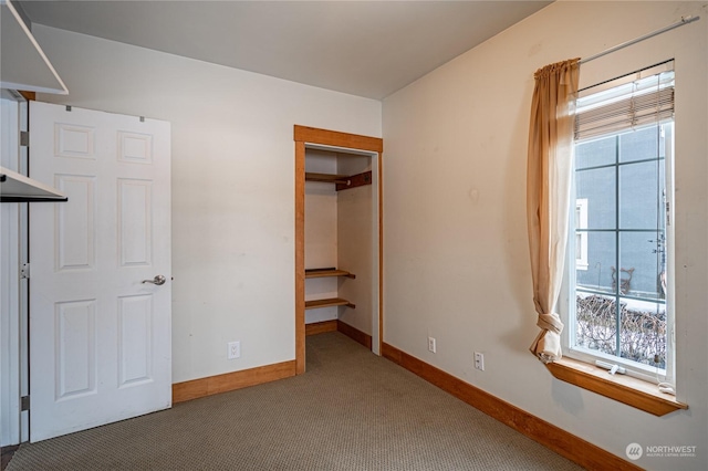 unfurnished bedroom featuring a closet and carpet floors