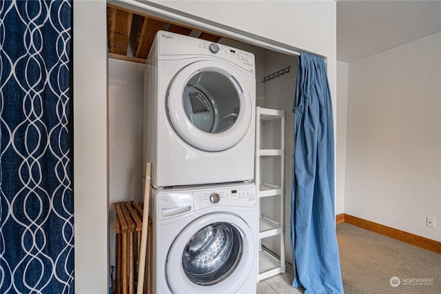 laundry room featuring stacked washer and clothes dryer and light carpet