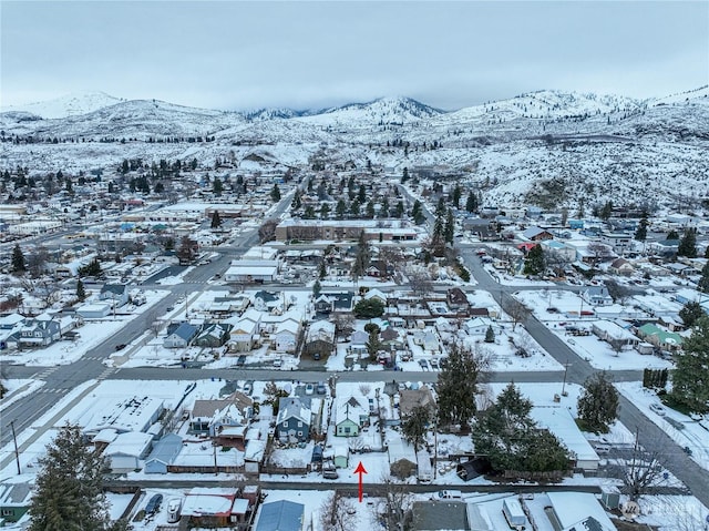 snowy aerial view with a mountain view