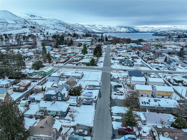 snowy aerial view with a mountain view