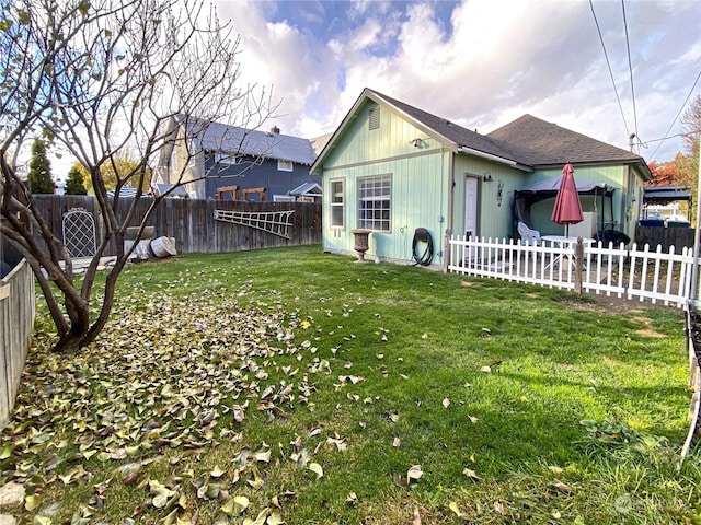 view of side of property with a yard