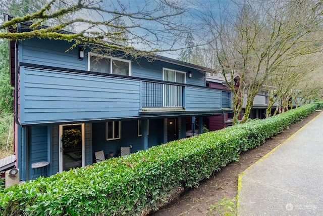 view of side of property featuring a balcony