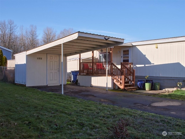 exterior space featuring a front yard and a carport