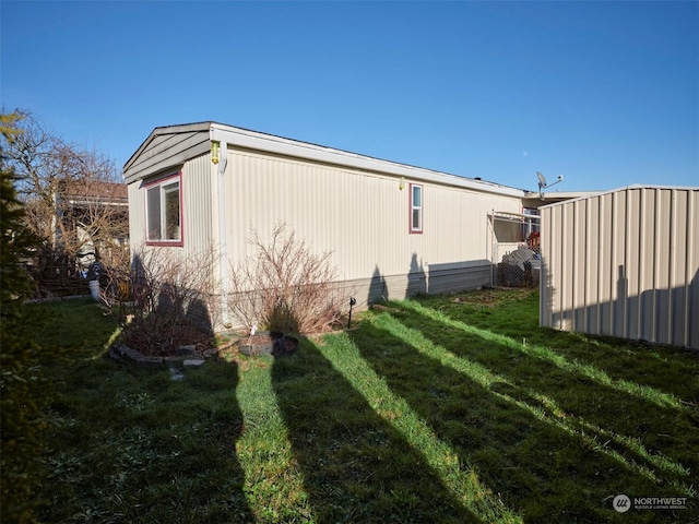 view of side of property with a yard