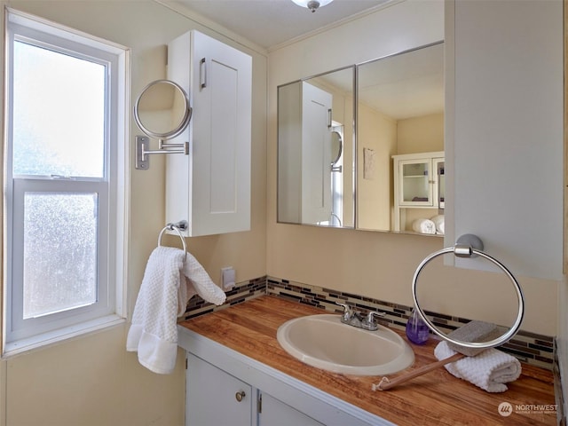 bathroom featuring vanity and backsplash