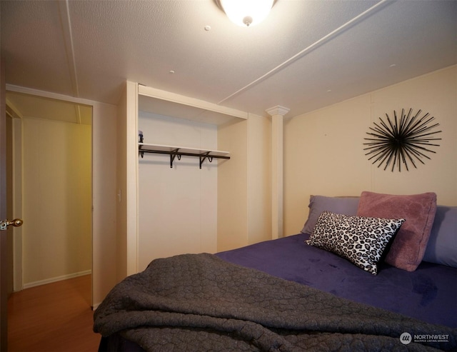 bedroom with a closet and hardwood / wood-style flooring