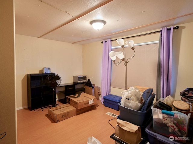 interior space with hardwood / wood-style floors and a textured ceiling