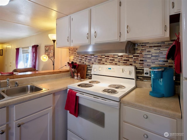 kitchen featuring backsplash, electric range, sink, and white cabinets