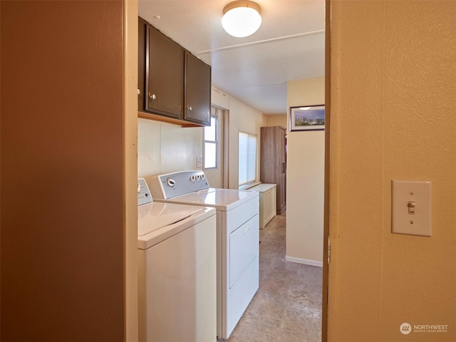 laundry room with cabinets and washing machine and dryer