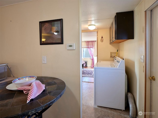 laundry area with washer and clothes dryer and cabinets