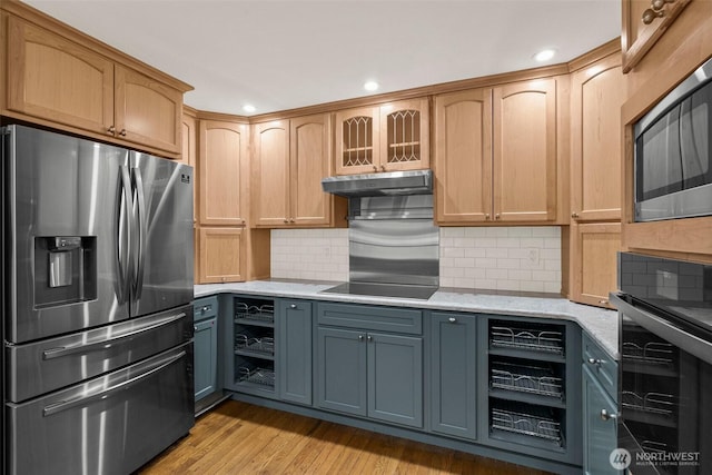 kitchen featuring black electric stovetop, gray cabinetry, under cabinet range hood, stainless steel fridge with ice dispenser, and light stone countertops