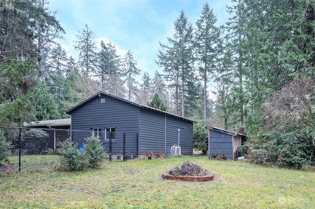 view of property exterior with a storage unit and a yard