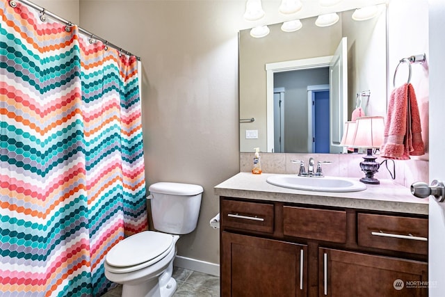 bathroom with vanity, curtained shower, and toilet