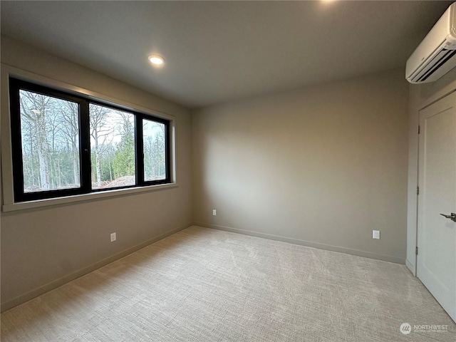 carpeted empty room featuring a wall unit AC