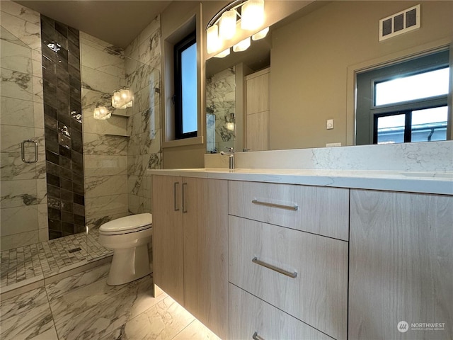 bathroom with walk in shower, vanity, and toilet