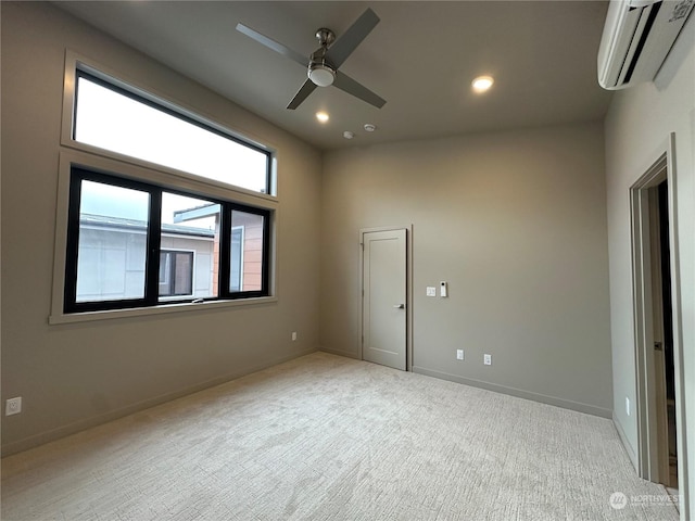 carpeted empty room featuring a wall mounted AC and ceiling fan