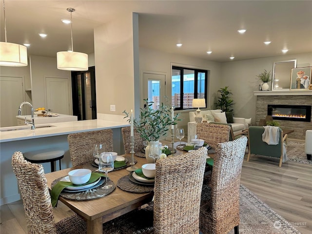 dining space with sink and light hardwood / wood-style flooring