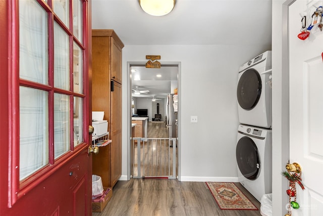 1989 NE Lisa Ln, Poulsbo, WA 98370 - washroom featuring wood finished floors, ceiling fan, baseboards, stacked washer and clothes dryer, and laundry area