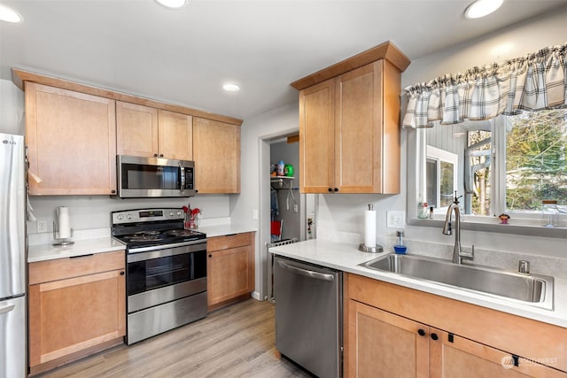 1989 NE Lisa Ln, Poulsbo, WA 98370 - kitchen featuring light brown cabinets, a sink, light wood-style floors, light countertops, and appliances with stainless steel finishes