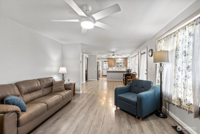 1989 NE Lisa Ln, Poulsbo, WA 98370 - living area with a ceiling fan, baseboards, and light wood-style flooring