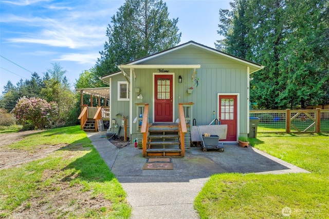 1989 NE Lisa Ln, Poulsbo, WA 98370 - view of front of home with a front lawn, fence, and board and batten siding