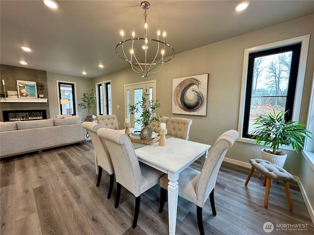 dining area with hardwood / wood-style flooring and a chandelier