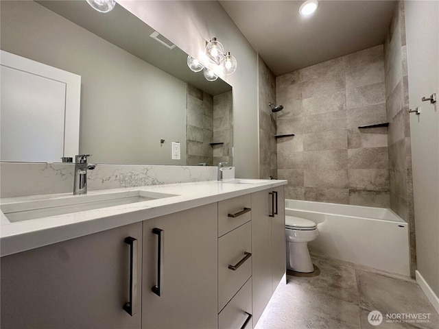 full bathroom with tiled shower / bath combo, vanity, and toilet