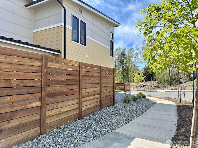 view of side of property featuring fence
