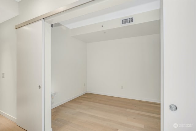 empty room with light hardwood / wood-style flooring