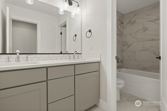 full bathroom featuring tiled shower / bath combo, toilet, vanity, and tasteful backsplash